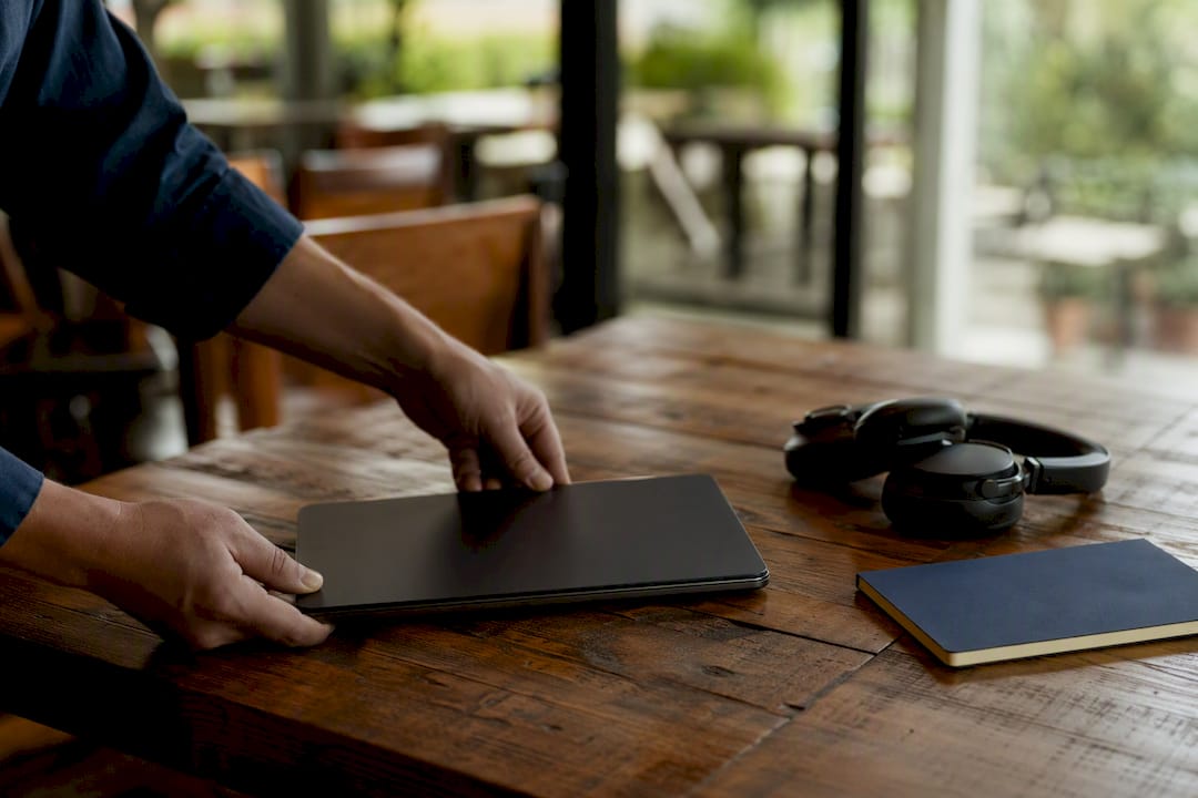 Hands holding tablet face down for human oversight