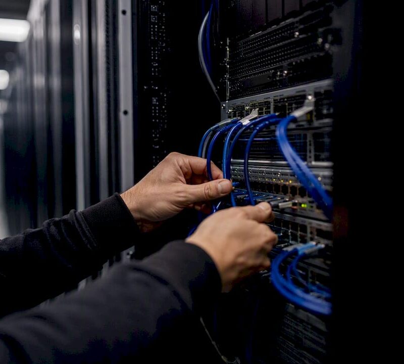 Hands connecting cables for financial data automation