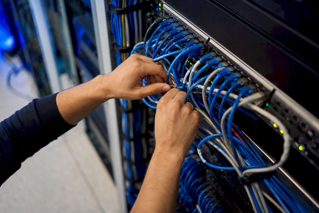Hands wiring network cables for legacy system integration